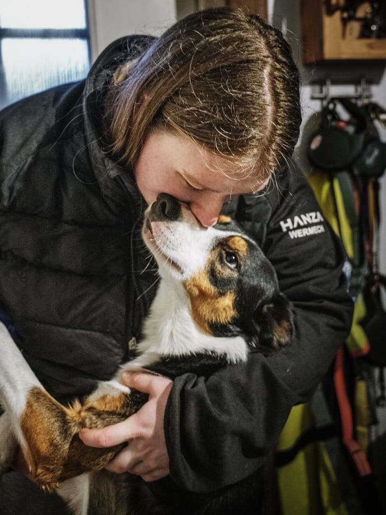 Therese van der Veer gosar med sin hund hemma i hallen.