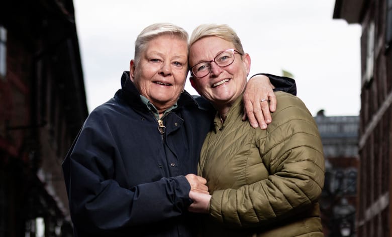 Marie Bjuhr har armen om axlarna på Ulrika Häller. De är utomhus och har svart respektive olivgrön vinterjacka. 